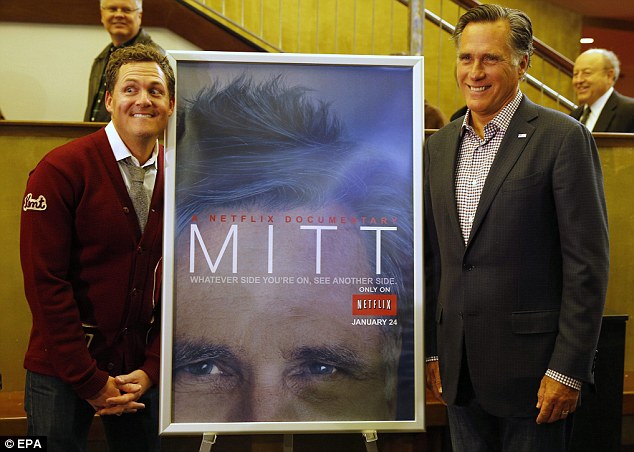 Director Greg Whitely (L) and Mitt Romney (R) pose for a fun picture by a 'Mitt' movie poster before the premiere of 'Mitt' during the 2014 Sundance Film Festival in Salt Lake City on Friday