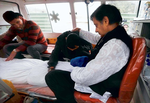 Grief: Shashi Tharoor with Sunanda Pushkar's son Shiv in the ambulance with her body