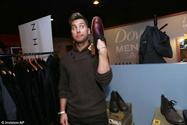 Being funny: Lance Bass posed for a photo with a brown dress shoe on his hand