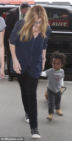 After the event: Later actress Connie Britton was seen looking laid back with her adopted son Eyob as she arrived at LAX