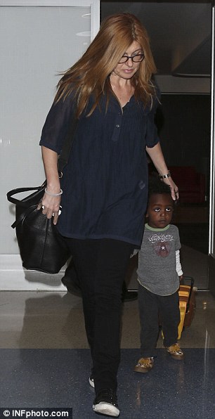 After the event: Later actress Connie Britton was seen looking laid back with her adopted son Eyob as she arrived at LAX