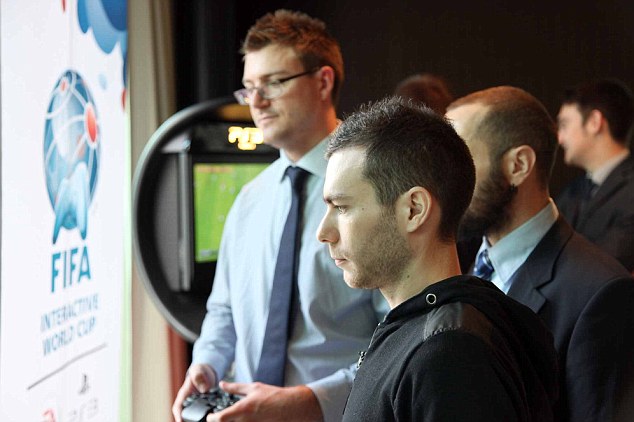 Game on! Sportsmail's Adam Shergold (background) took on the best FIFA 13 gamer in the world Bruce Grannec (front) before the Ballon d'Or ceremony in Zurich