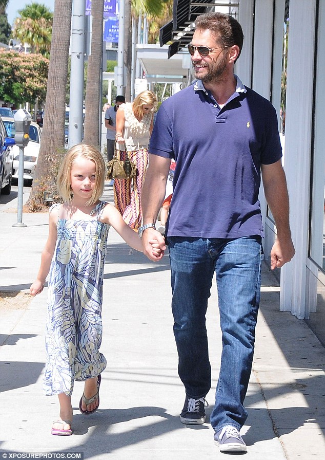 There's a smile: Jason cracked a toothy smile as he squired Ava down the sidewalk by the hand