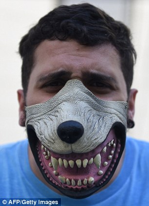 A Uruguay fan wearing a dog mask