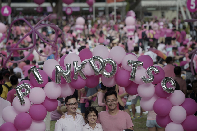 Gay activists dressed in pink, pose for photos on Saturday, June 28, 2014 in Singapore. Thousands of gay rights activists gathered in downtown Singapore on S...