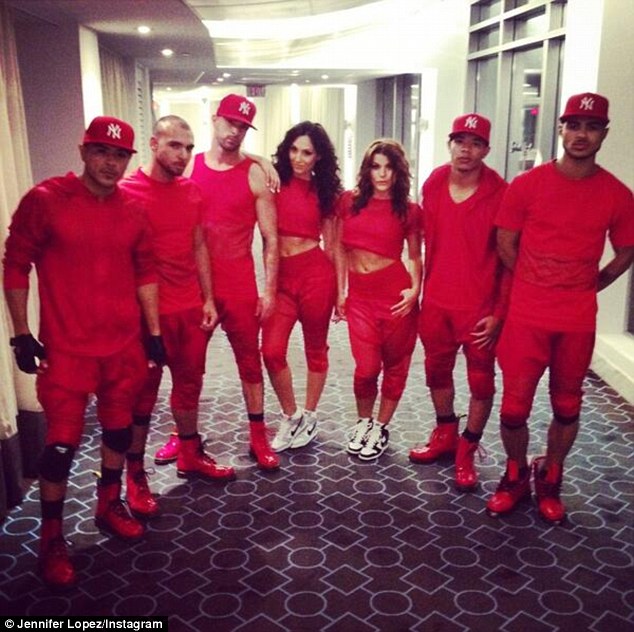 Red team: The brunette beauty tweeted this image on Saturday night, writing, 'jlodancers before they storm the stage!'