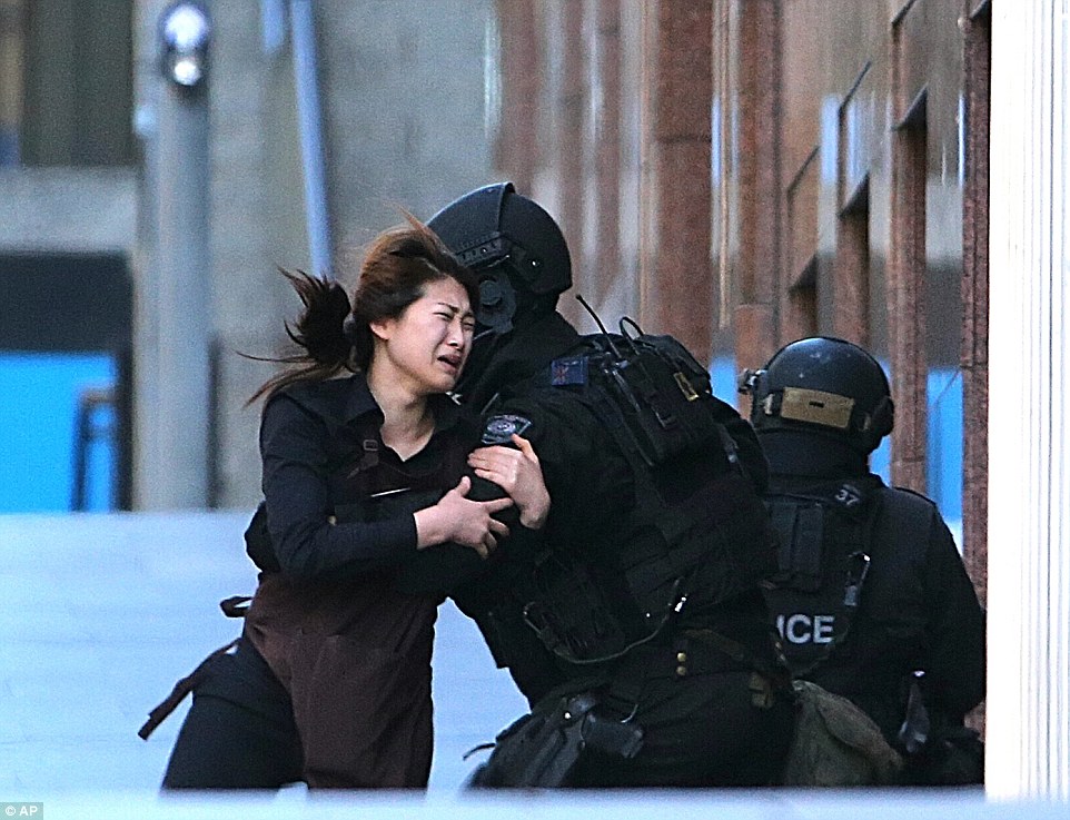 A young female employee  came running out of the Lindt cafe shortly before 5pm on Monday and was sheltered by waiting police