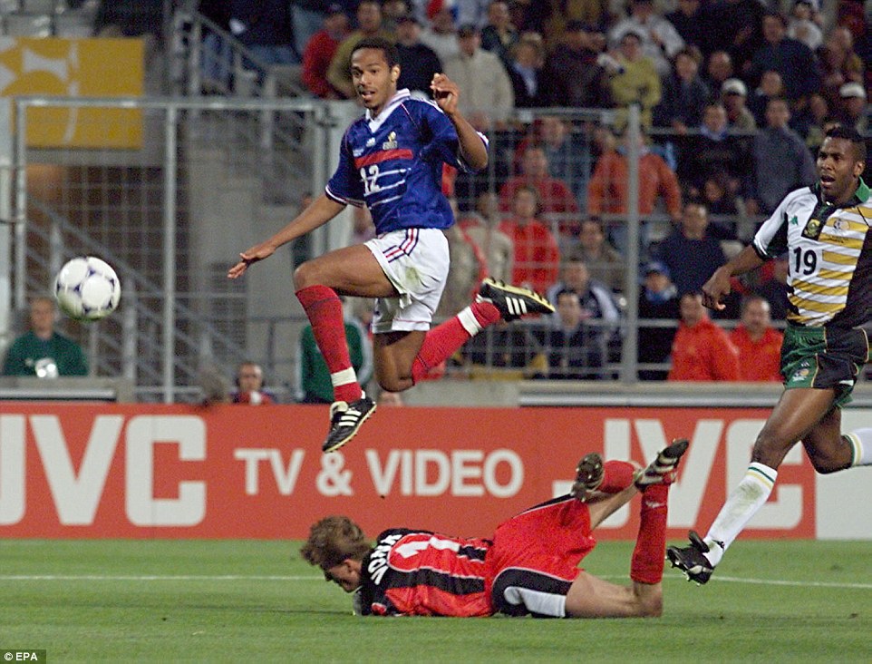 Henry hurdles South Africa goalkeeper Hans Vonk after firing the ball into the net during a group stage match at the 1998 World Cup