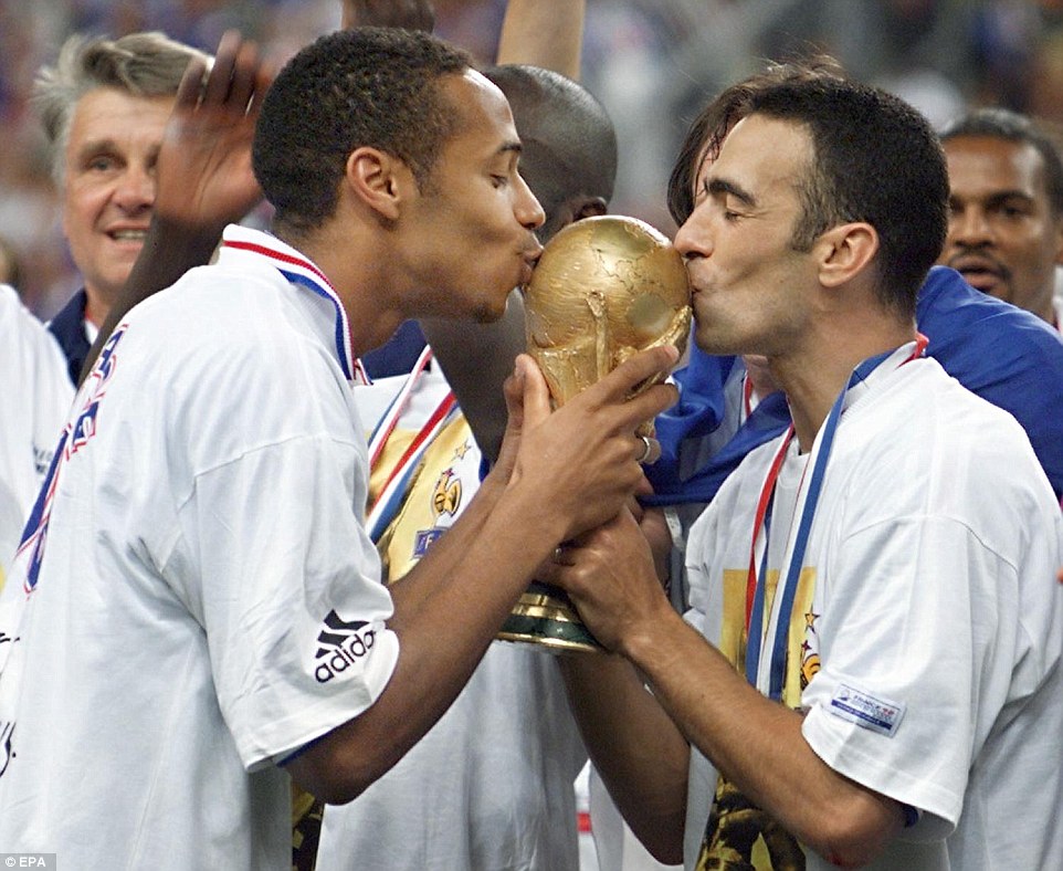 Henry and Youri Djorkaeff kiss the World Cup trophy after France's famous 3-0 win over Brazil at the Stade de France in Paris