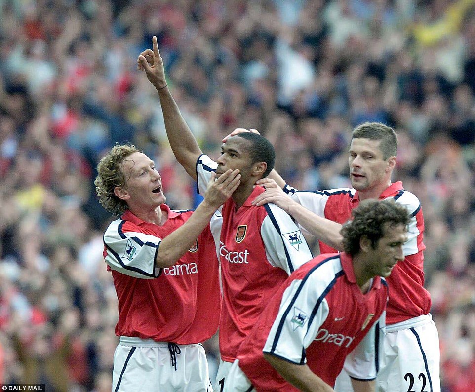 Henry is congratulated by Ray Parlour after his wondrous goal against Manchester United at Highbury in October 2000