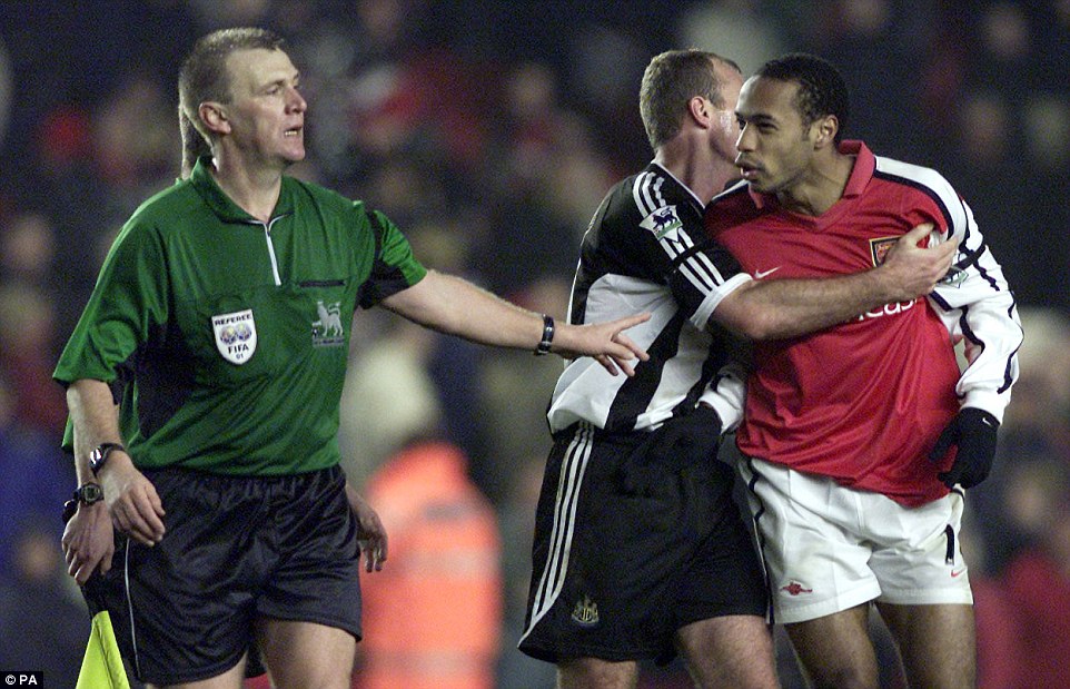 Held back by Newcastle striker Alan Shearer as he tries to remonstrate with referee Graham Poll after a 3-1 loss in December 2001