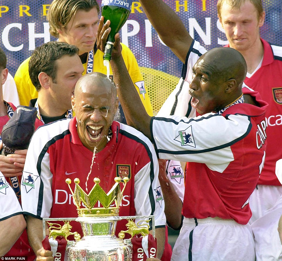 Doused in champagne by Sol Campbell after Arsenal won the Premier League title in 2002, completing another Double after 1971 and 1998