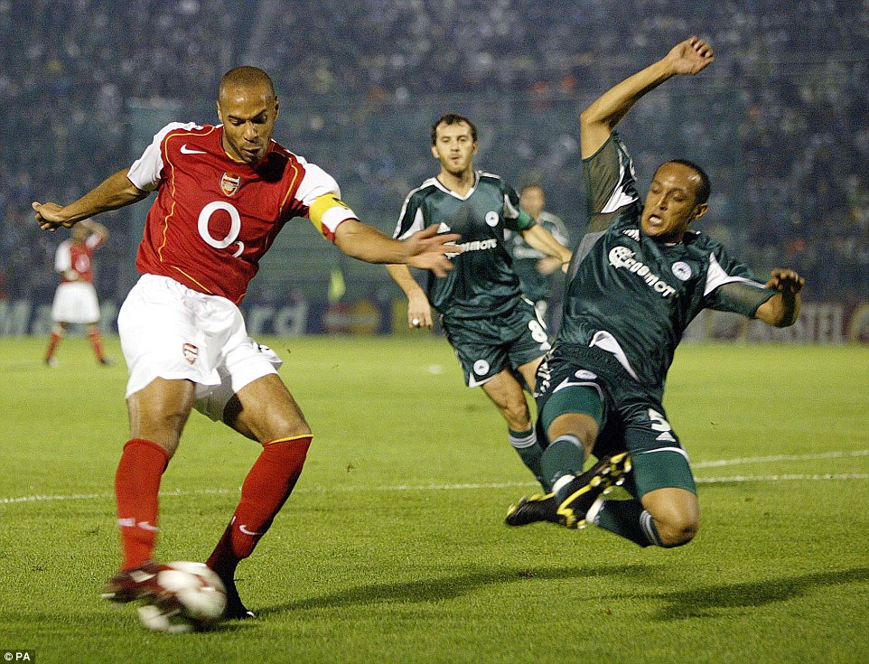 Defenders would sometimes have to resort to desperate measures to stop Henry, such as this lunge by Nasief Morris of Panathinaikos 