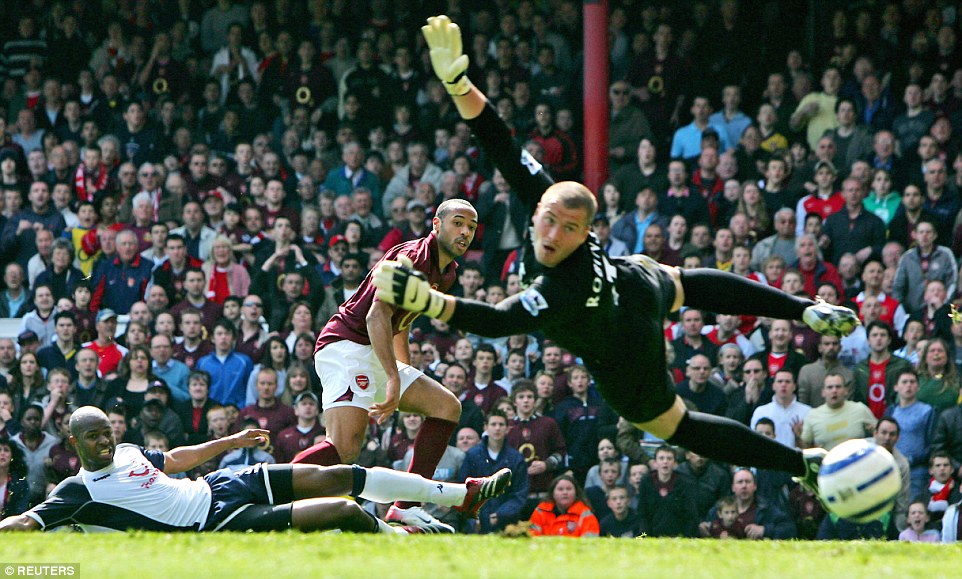 Goalkeeper Paul Robinson can only look back in despair as Henry bends the ball home in the north London derby with Spurs in 2006