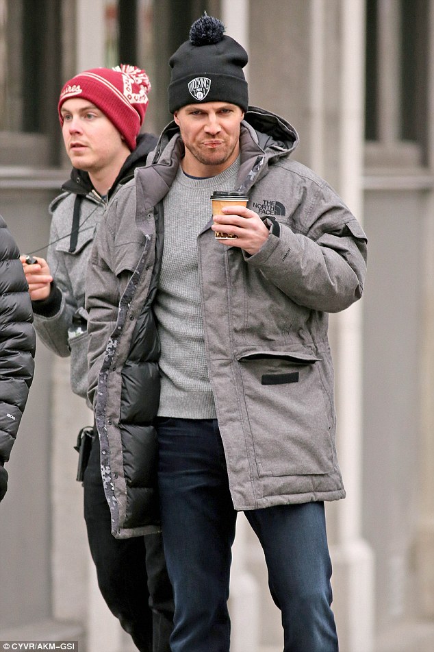 Bundled up: Earlier in the day, Stephen looked vastly different as he donned a black beanie, The North Face jacket and skinny blue jeans