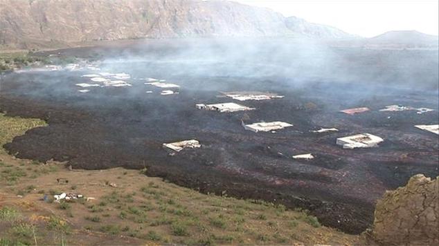 Screengrab from video footage obtained by AFP from TCV (Televisão de Cabo Verde) shows lava from the Pico do Fogo volcano surrounding houses on the island of...