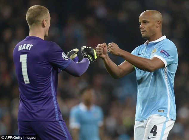 Joe Hart and Vincent Kompany (right) celebrate Manchester City's 2-1 win over Sevilla in midweek 