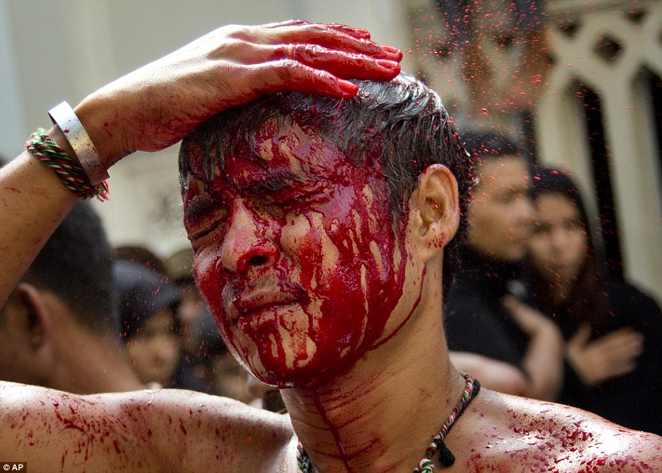 Blood drips from the head of a young Shi'ite Muslim in Myanmar - one of thousands to self-flagellate on the holy Day of Ashura today