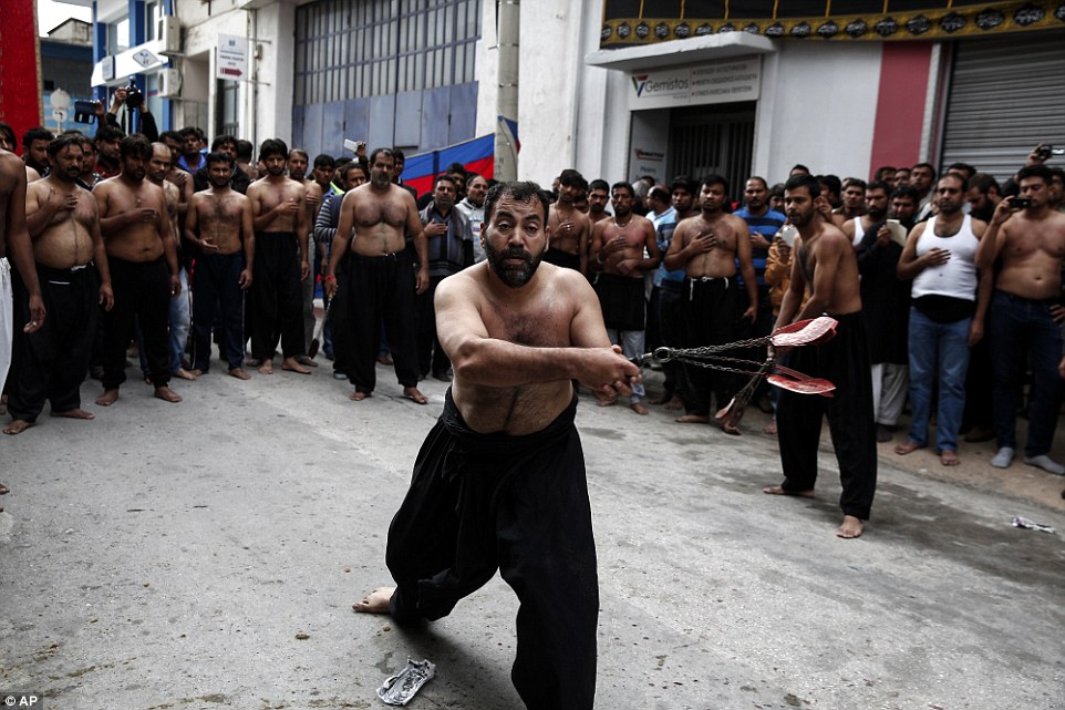 Men in Athens, Greece (pictured), lash their own backs with sharpened knives and chains to mourn Imam Hussein who died in the Battle of Karbala in 680 AD