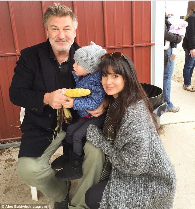 Autumn day out: The New York-based family paused to take a photo together while Carmen took a break from eating her roasted corn