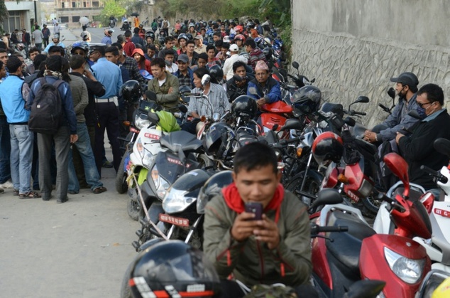 Motorists queue outside a gas station as fuel rations are implemented in Kathmandu, on October 15, 2015 due to a blockade on a key Indian border checkpoint