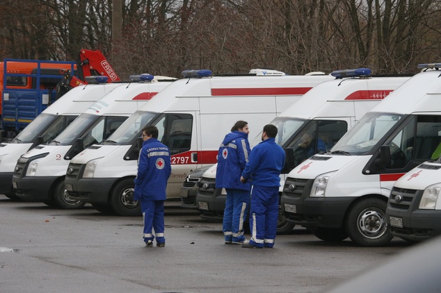 Russian Ministry for Emergency Situations paramedics stand next to their ambulance cars at a city morgue in St.Petersburg, Russia, Monday, Nov. 2, 2015. Metr...