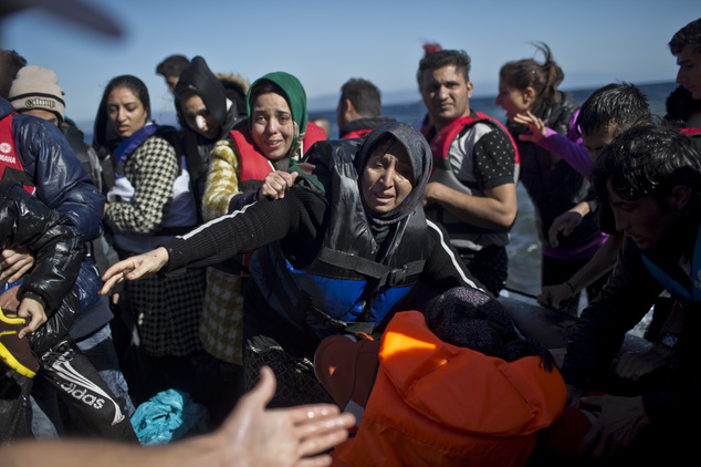 People rush to disembark a small boat at a beach on the northern shore of Lesbos, Greece, Monday, Nov. 2, 2015. More than 300,000 people have traveled on din...