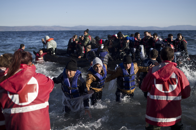 People rush to disembark from a rubber boat at a beach on the northern shore of Lesbos, Greece, Monday, Nov. 2, 2015. The number of smuggling boats crossing ...