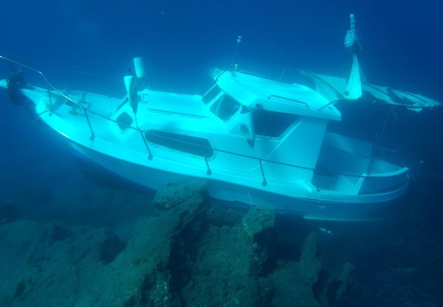 Kusadasi Ilgun, the sunken 6-meter (20-foot) plastic boat, lies in waters 3 meters (10 feet) deep just 20 meters (yards) off the eastern Greek island of Samo...