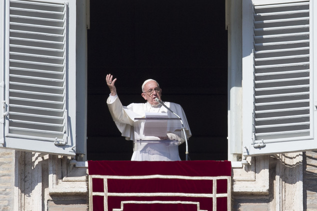 Pope Francis delivers his blessing during the Angelus noon prayer he celebrated from the window of his studio overlooking St. Peter's Square, at the Vatican,...