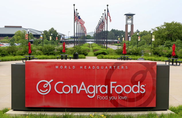 FILE - In this Tuesday, June 30, 2015, file photo, flags fly over ConAgra Foods world headquarters in Omaha, Neb. ConAgra Foods Inc. is selling its private l...