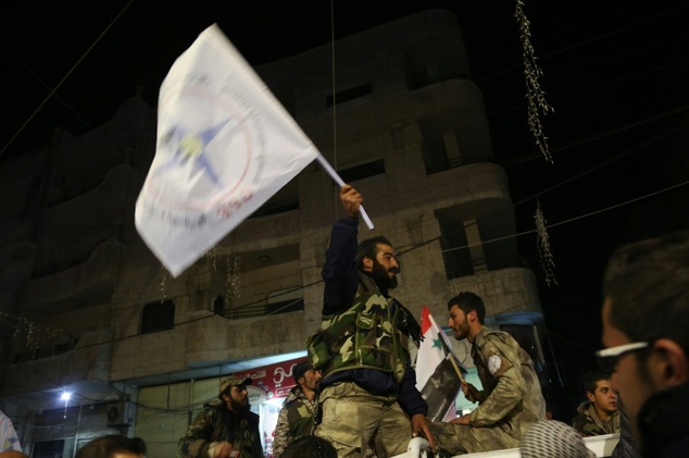 Members of the Assyrian Gozarto Protection Forces celebrate upon their return from ongoing battles against the Islamic State group on the outskirts of the Sy...