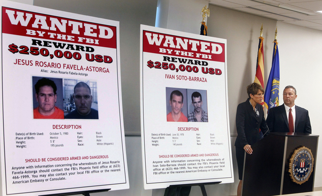 FILE - In this July 9, 2012, file photo, with wanted posters off to the side, Laura E. Duffy, United States Attorney Southern District of California, and FBI...