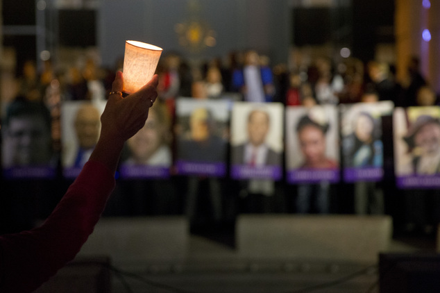 Arlene Payan holds a candle during a vigil to honor shooting victims on Monday, Dec. 7, 2015, in San Bernardino, Calif. The husband and wife who opened fire ...