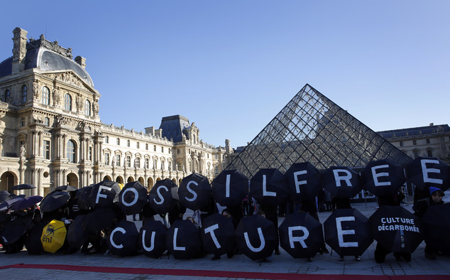 Activists  stage a protest  outside  the Louvre pyramid, calling on the museum to cancel its  contracts with French oil giant Total and Italian oil company E...