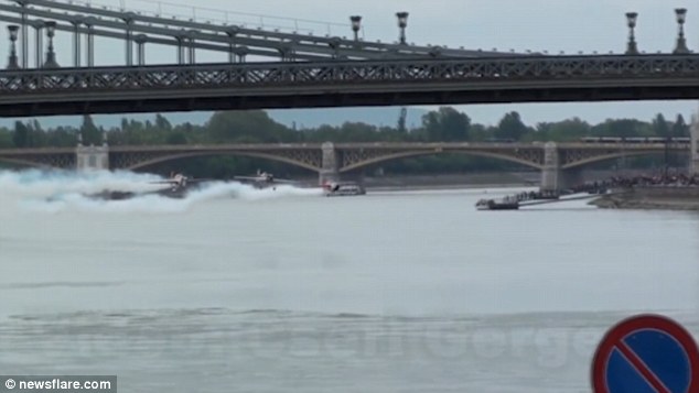 Flying in: This is the dramatic moment a stunt plane narrowly avoided a deadly crash during a Guinness World Record attempt. It was one of three performing an acrobatic routine over the river Danube in Budapest