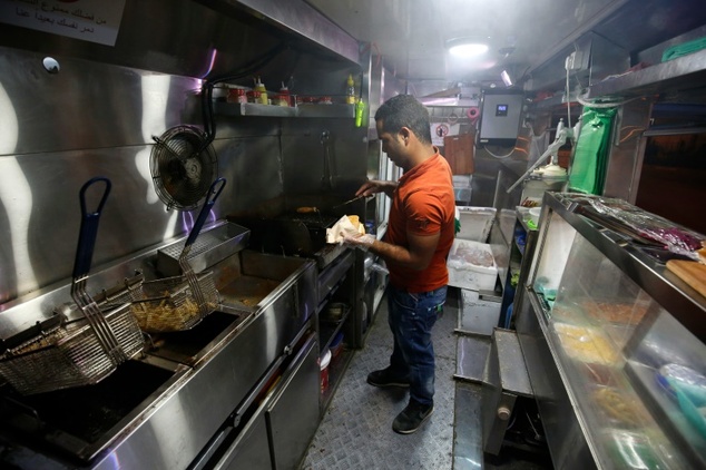 Palestinians Khaldun al-Barghuthi and Abderrahman al-Bibi's brightly coloured food van is drawing attention -- and hungry patrons -- on the pavements and in ...