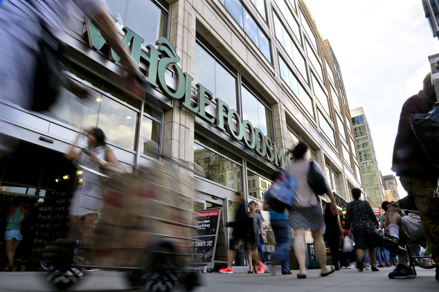 FILE - In this Wednesday, June 24, 2015, file photo, pedestrians pass in front of a Whole Foods Market store in Union Square, in New York. Whole Foods Market...