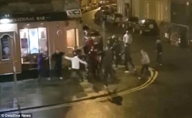 The video appears to show a large crowd of Hibs and Hearts fans exchange blows outside a pub in Edinburgh following Sunday's derby match