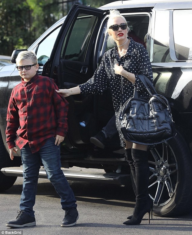 Out and about: Gwen donned a beautiful black-and-white polka dot dress which she teamed with thigh-high boot-heels