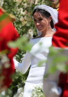 the bride smiles as she walks down the aisle