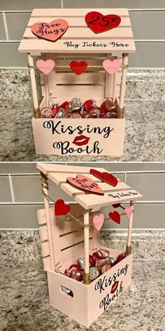 two wooden boxes with hearts on them and the words kissing booth written in black ink