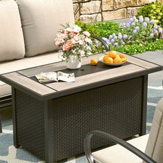 a table that has some oranges on it and a bowl of fruit sitting on top of it