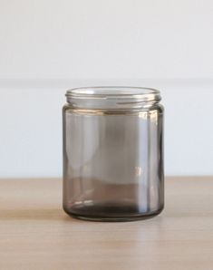 a glass jar sitting on top of a wooden table