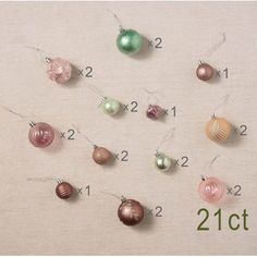 twelve christmas ornaments hanging from strings on a white background with the numbers 21 to 22