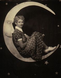 an old photo of a woman sitting on the moon