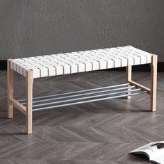 a white bench sitting on top of a hard wood floor next to a computer mouse