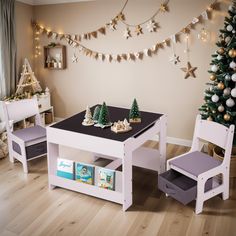 a child's play table and chair set in front of a christmas tree