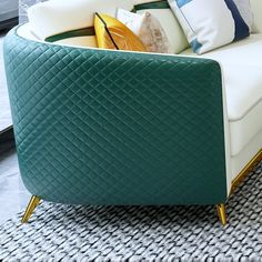 a green and white couch sitting on top of a rug