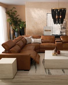 a living room filled with lots of brown furniture